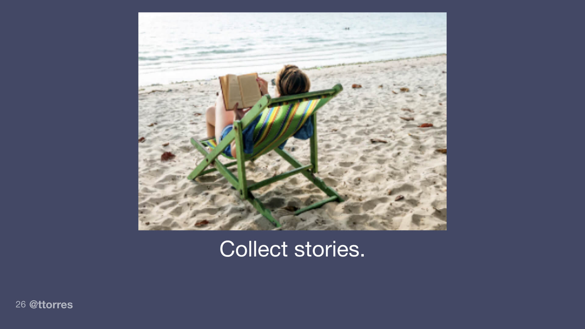 A person sitting on the beach reading a book.