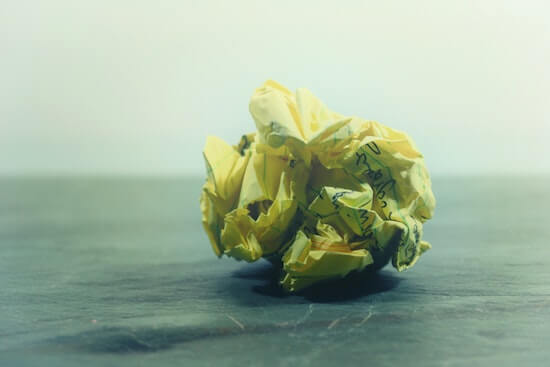 A crumpled up piece of paper with writing on it