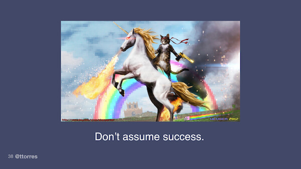 An image of a cat riding a fire-breathing unicorn in front of a rainbow