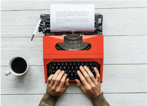 A person typing on a typewriter.