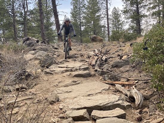 Teresa mountain biking on rugged, rocky terrain