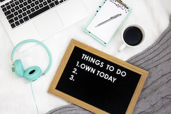 A notebook and a black board with the text "Things to do" written on it.