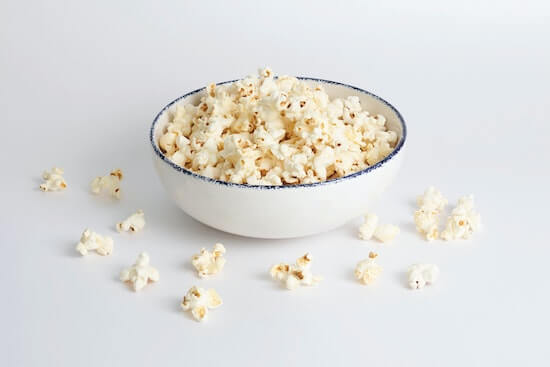 A bowl of popcorn on a table.