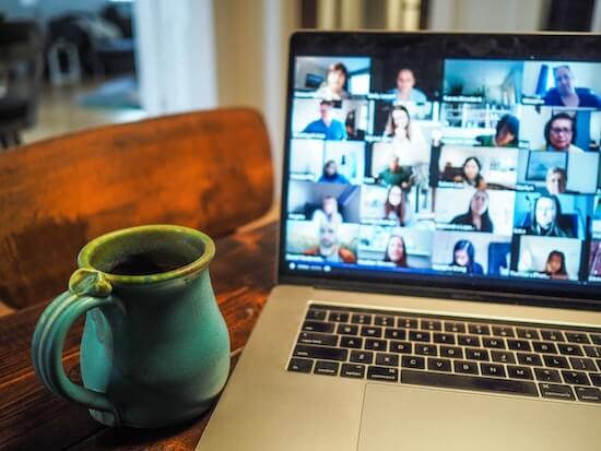 A photograph of a laptop showing a number of students participating in a virtual class.