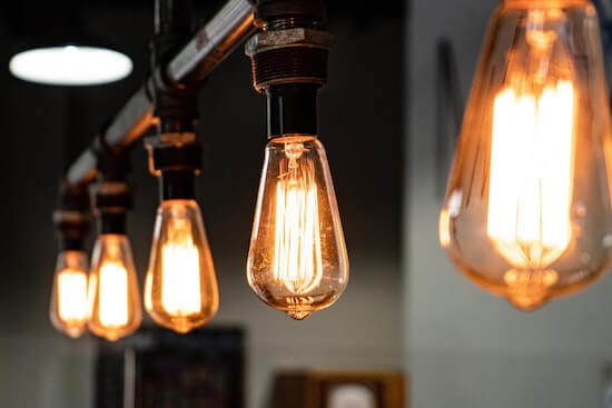 A photograph of a row of lit lightbulbs